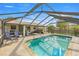 Relax in a screened-in pool with ample seating and a clear view of the sky at 5720 Se 20Th St, Ocala, FL 34480