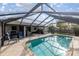 Relaxing screened-in pool with lounge chairs and outdoor grill, perfect for entertaining at 5720 Se 20Th St, Ocala, FL 34480