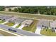 Aerial view of houses on a street with green lawns, a boundary fence, and cars parked in the driveways at 5842 Sw 78Th Avenue Rd, Ocala, FL 34474