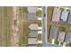 Overhead image of modern house roofs next to each other with green lawns, and cars parked along the street at 5842 Sw 78Th Avenue Rd, Ocala, FL 34474