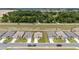 Aerial view of several houses on a street with green lawns, boundary fences, and cars parked in the driveways at 5842 Sw 78Th Avenue Rd, Ocala, FL 34474