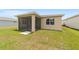 View of the backyard with a screened patio, lush green grass, and neutral siding at 5842 Sw 78Th Avenue Rd, Ocala, FL 34474