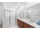 Bright bathroom with dual sinks, white countertops, glass shower, and ample mirror space at 5842 Sw 78Th Avenue Rd, Ocala, FL 34474