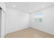 Empty bedroom space with window light, neutral tile floors, and a modern feel at 5842 Sw 78Th Avenue Rd, Ocala, FL 34474