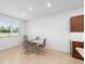 Dining area with modern table and chairs, natural light, and adjacent kitchen cabinetry at 5842 Sw 78Th Avenue Rd, Ocala, FL 34474