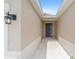 Covered entryway showcasing a sleek front door and a modern outdoor lighting fixture at 5842 Sw 78Th Avenue Rd, Ocala, FL 34474