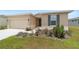 Beautiful single-story home featuring manicured flowerbeds, a green lawn, and a convenient two car garage at 5842 Sw 78Th Avenue Rd, Ocala, FL 34474
