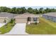 Well-manicured front yard of home with a two-car garage, beautiful landscaping, and a concrete driveway at 5842 Sw 78Th Avenue Rd, Ocala, FL 34474