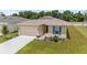 Well-manicured front yard of home with a two-car garage, beautiful landscaping, and a concrete driveway at 5842 Sw 78Th Avenue Rd, Ocala, FL 34474