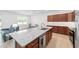 Open kitchen with granite countertops, modern appliances, and seamlessly flows into dining area at 5842 Sw 78Th Avenue Rd, Ocala, FL 34474