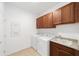 Well-equipped laundry room with modern washer, dryer, and ample cabinet storage at 5842 Sw 78Th Avenue Rd, Ocala, FL 34474