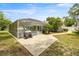 The screened-in pool, outdoor seating and partially shaded backyard create a comfortable outdoor space at 6070 Se 39Th Ave, Ocala, FL 34480