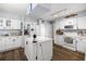 Updated kitchen featuring an island, white cabinets, modern appliances, and wood-look flooring at 6070 Se 39Th Ave, Ocala, FL 34480