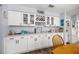 Kitchen featuring white cabinetry, granite countertops, and stainless steel appliances with views of the dining area at 6070 Se 39Th Ave, Ocala, FL 34480