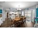 Bright eat-in kitchen with white cabinetry, center island, stainless appliances, wood floors and sliding door at 6070 Se 39Th Ave, Ocala, FL 34480