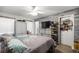 Main bedroom with wood-look floors, neutral colors, a ceiling fan, and organized storage solutions at 6070 Se 39Th Ave, Ocala, FL 34480