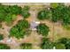 Aerial shot of a home nestled among lush trees, showcasing privacy and seclusion at 6350 Nw 135Th Ave, Morriston, FL 32668
