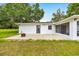 Covered patio area offering a relaxing space, complemented by a spacious backyard and well-kept lawn at 6350 Nw 135Th Ave, Morriston, FL 32668