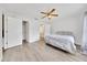 Bright bedroom with wood-look floors, a ceiling fan, and a closet with white doors at 6350 Nw 135Th Ave, Morriston, FL 32668
