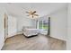 Serene bedroom with wood-look floors, a ceiling fan, and a bright window at 6350 Nw 135Th Ave, Morriston, FL 32668