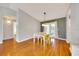 Dining area with hardwood floors, stylish table, and access to outdoor patio at 6350 Nw 135Th Ave, Morriston, FL 32668