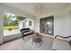 Relaxing screened patio with wicker furniture and peaceful backyard views at 6350 Nw 135Th Ave, Morriston, FL 32668