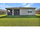 Rear exterior featuring a covered patio and backyard, providing a relaxing outdoor space at 6405 Sw 88Th Loop, Ocala, FL 34476