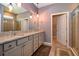 Bathroom featuring granite countertop, double vanity, modern lighting, and glass shower at 6405 Sw 88Th Loop, Ocala, FL 34476