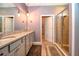 Bathroom featuring granite countertop, double vanity, modern lighting, and glass shower at 6405 Sw 88Th Loop, Ocala, FL 34476