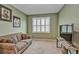 Neutral-toned room with beige couch and television at 6405 Sw 88Th Loop, Ocala, FL 34476