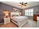 Bedroom featuring a ceiling fan, a window with shutters, a cow themed art, and carpet flooring at 6405 Sw 88Th Loop, Ocala, FL 34476