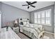 Cozy bedroom with natural light, neutral paint, ceiling fan, and carpet flooring at 6405 Sw 88Th Loop, Ocala, FL 34476