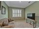 Neutral-toned room with beige couch and television at 6405 Sw 88Th Loop, Ocala, FL 34476
