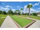 Bocce ball court with turf, wood trim, and walking path, lined with palm trees at 6405 Sw 88Th Loop, Ocala, FL 34476