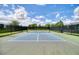 Pickleball court with net and fencing, surrounded by trees and greenery at 6405 Sw 88Th Loop, Ocala, FL 34476