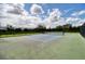 Pickleball court with net and fencing, surrounded by trees and greenery at 6405 Sw 88Th Loop, Ocala, FL 34476