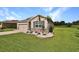 Attractive single-story home with stone accents, blue shutters, and a lush green lawn at 6405 Sw 88Th Loop, Ocala, FL 34476