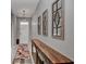 Entry hall featuring neutral colors, decorative mirrors, and elegant light fixtures at 6405 Sw 88Th Loop, Ocala, FL 34476