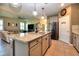 Open kitchen with granite island, stainless appliances, and view to the living room at 6405 Sw 88Th Loop, Ocala, FL 34476