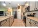 Spacious kitchen with stainless steel appliances, granite counters, and a large island at 6405 Sw 88Th Loop, Ocala, FL 34476