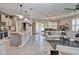 Open-concept living area with stylish furniture, modern lighting, and access to the outdoor space at 6405 Sw 88Th Loop, Ocala, FL 34476
