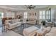 Open-concept living room with tile floors, ceiling fan, and neutral decor at 6405 Sw 88Th Loop, Ocala, FL 34476