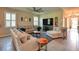 Bright living room with stylish decor, ceiling fan, tile floors, and lots of natural light at 6405 Sw 88Th Loop, Ocala, FL 34476