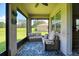 Charming enclosed patio provides an extension to the living space with views of the backyard at 6405 Sw 88Th Loop, Ocala, FL 34476
