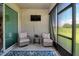 Relaxing outdoor patio with comfortable seating, TV, and scenic views of the green surroundings at 6405 Sw 88Th Loop, Ocala, FL 34476