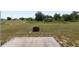 Large backyard with a firepit, a concrete slab and ample room to add a patio at 6561 Sw 129Th Loop, Ocala, FL 34473