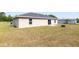 Large backyard featuring a fire pit, small patio and a neutral exterior at 6561 Sw 129Th Loop, Ocala, FL 34473