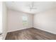 This bedroom includes wood-look flooring, neutral walls, a ceiling fan, and a window with blinds at 6561 Sw 129Th Loop, Ocala, FL 34473