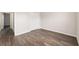 Bedroom featuring wood-look flooring, a closet, fresh paint, and convenient access to the hallway at 6561 Sw 129Th Loop, Ocala, FL 34473