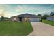 Charming single-story home with a well-manicured lawn and a two-car garage at 6561 Sw 129Th Loop, Ocala, FL 34473